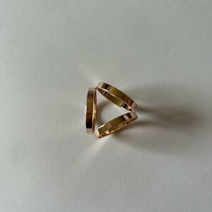 Rose gold tone interlocking scarf ring model sculptural design